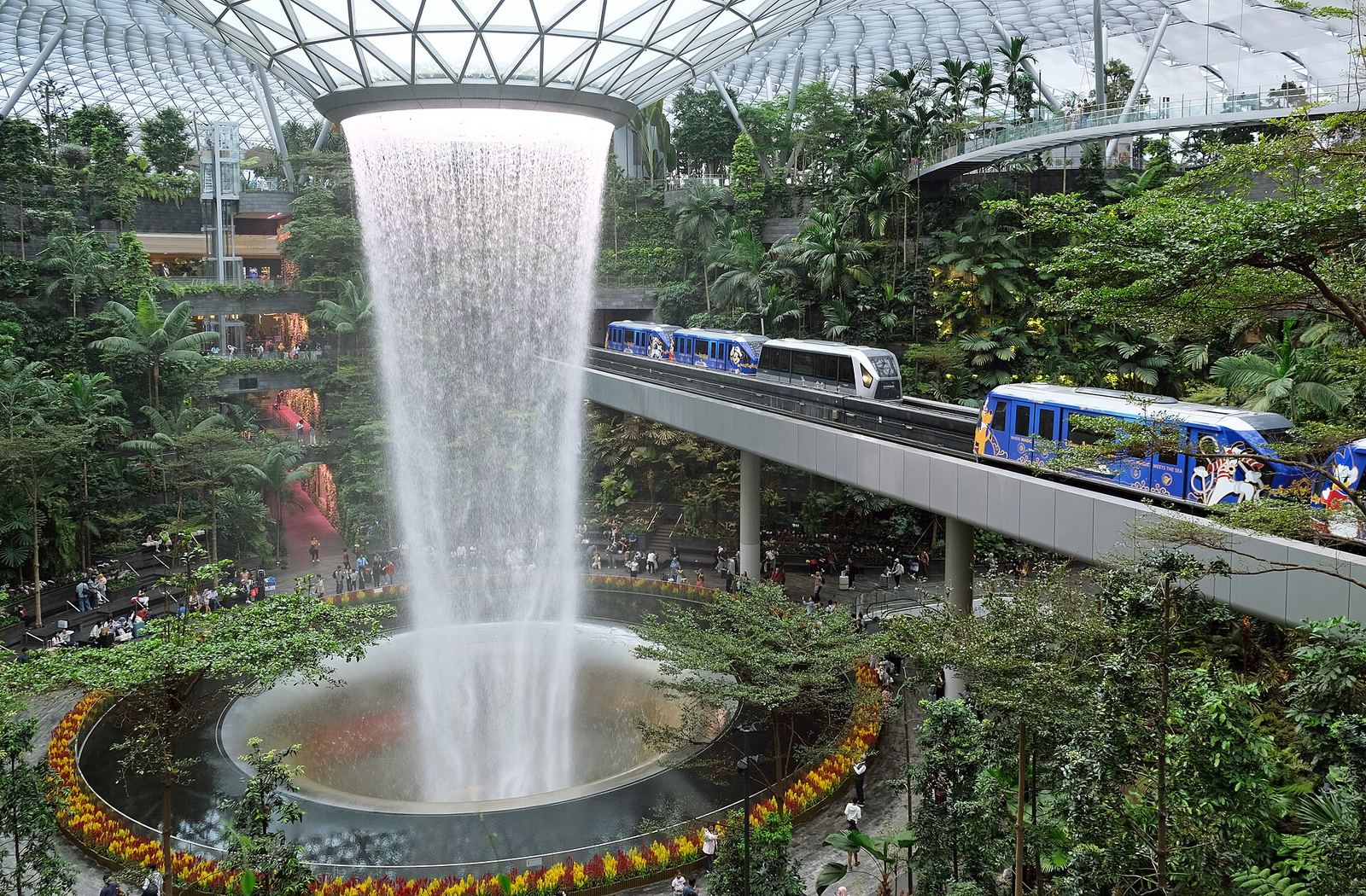 The Rain Vortex indoor waterfall surrounded by gardens inside Jewel Changi Airport